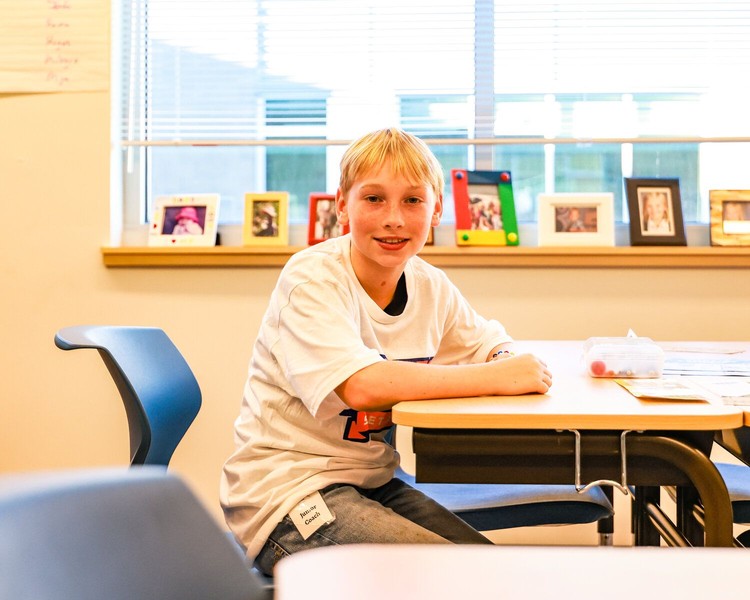 Elliott, a fifth-grade student, sits at his classroom desk during a student-led tour of the new Sunset Ridge Elementary School campus in Ridgefield on Thursday, Oct. 15.