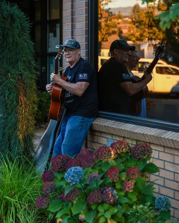 Randy Bumala plays a guitar and sings gospel outside of Battle Ground City Hall prior to the Monday, Oct. 5 Battle Ground City Council meeting where an invocation read by a member of the Satanic Temple of Washington.