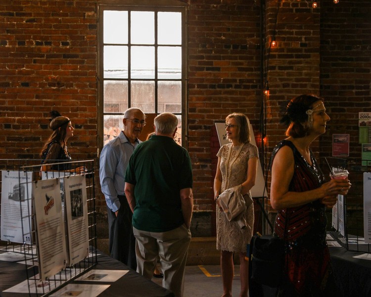 Attendees of the “Meeting History: Exploring Ridgefield’s Told and Untold Stories” pop-up museum event in the Greely Building in downtown Ridgefield mingle with each other on Friday, Aug. 21.