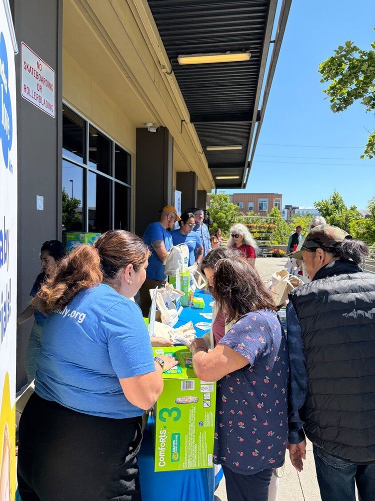 Akin staff engage with families at a diaper giveaway event.
