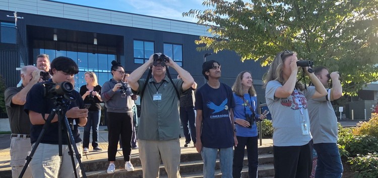 Shaunak Deshpande, wearing the “Cameraderie” shirt, a junior at Camas High School, helped teachers from the area learn how to spot birds at a recent workshop