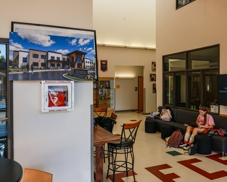 A rendering of the future Firm Foundation Christian School high school campus is on display just inside the main doors of Building B at the Meadow Glade-area K-12 campus.