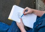 A sketch artist draws one of the counterprotesters outside of Battle Ground City Hall ahead of a city council meeting where invocations were approved by councilors with a 5-1 vote on Monday, Aug. 3.