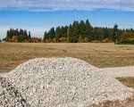 A pile of rock and a freshly laid gravel bypass road along Northeast Laurin Road sits adjacent to a 28.8-acre area of land owned by the Portland Vancouver Junction Railroad (PVJR) in Brush Prairie on Thursday, Oct. 22.