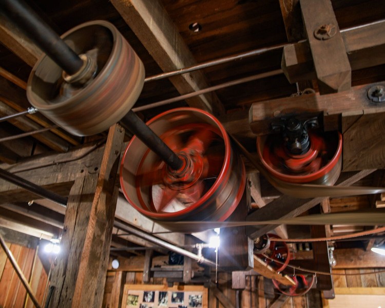 Wheels in the Cedar Creek Grist Mill turn while operating for milled flour on Wednesday, June 24.