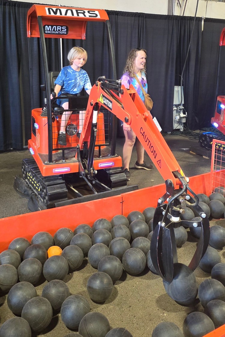 Jude Milauskas has perfect form as he mines for resources on Mars, with Chelsea Milauskas also having some fun on the red planet. They were enjoying their time with Mars Encounters, the featured exhibition for families at the Clark County Fair.