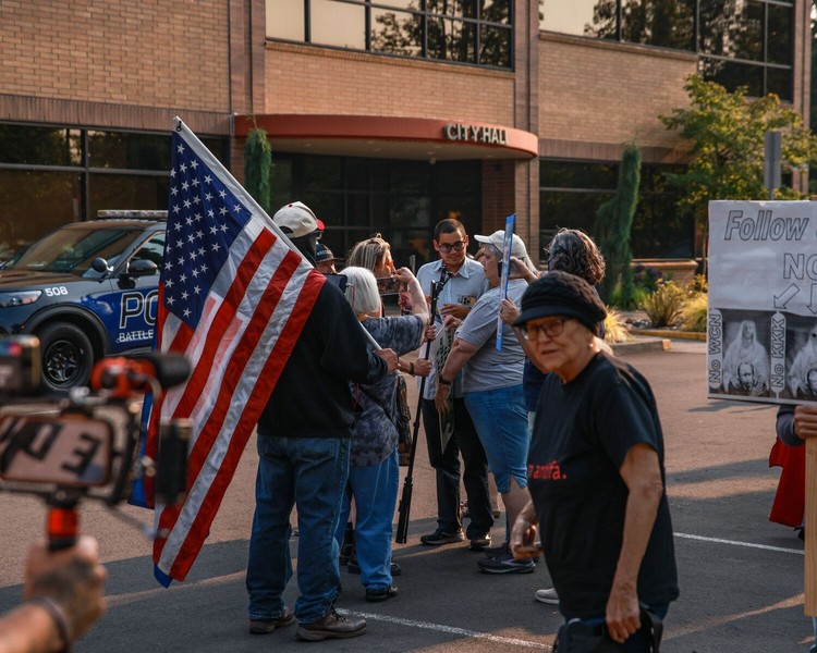 Protesters and counterprotesters stand toe-to-toe in front of Battle Ground City Hall ahead of a city council meeting where invocations were approved by councilors with a 5-1 vote on Monday, Aug. 3.